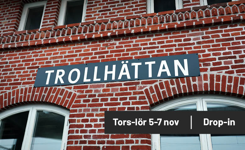 Tegelvägg med en skylt där det står Trollhättan