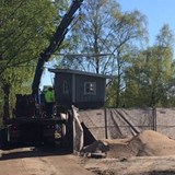 Skrotnisses verkstad lyfts ned från ett lastbilsflak och in till lekplatsen. 