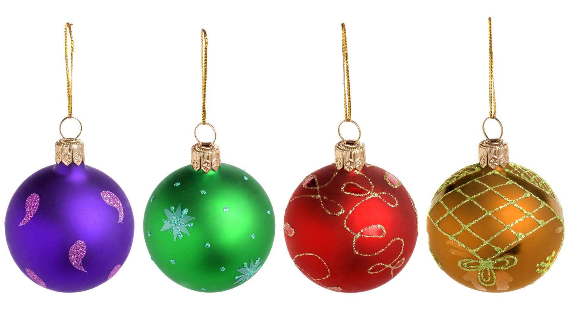Fyra julgranskulor i olika färger på rad