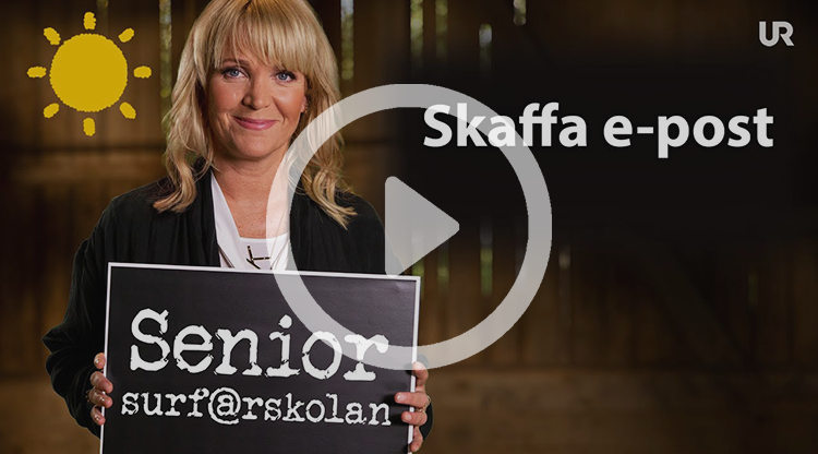 Kattis Ahlström håller upp en griffeltavla med texten Senior-surf@rskolan. På sidan av bilden står det: Skaffa e-post.
