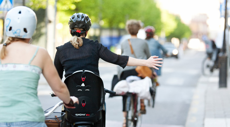 Cyklist som sträcker ut armen och pekar åt höger